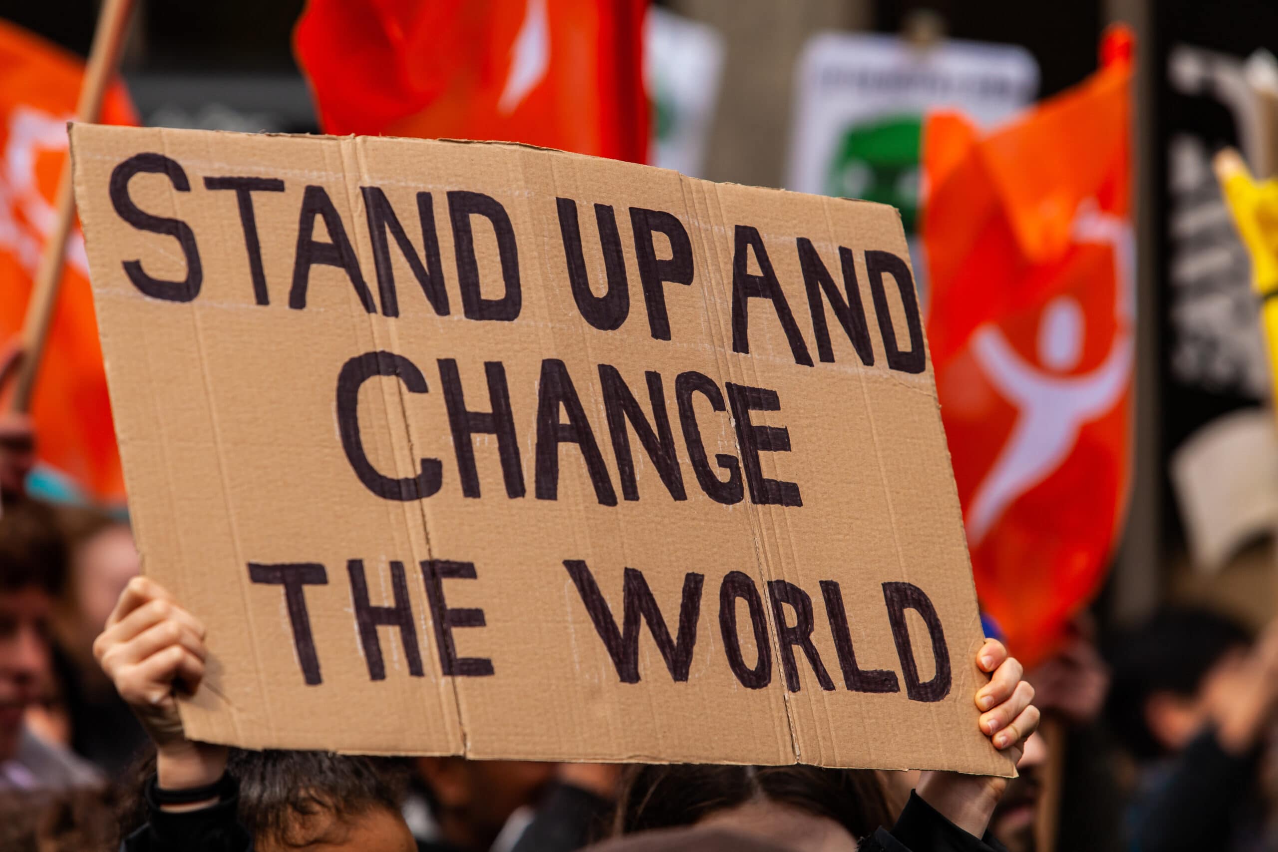 Protest banner that reads 'Stand up and change the world'